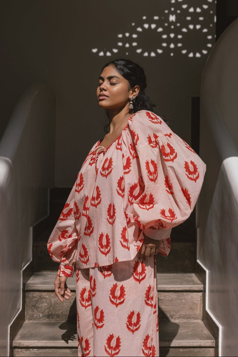 Ria Blouse Cherry Blossom — outdoor lifestyle portrait, model in natural setting, cherry blossom pink block print cotton blouse, Jaipur artisan made | Daughters of India